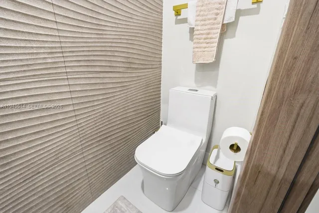 a white toilet sitting next to a white sink