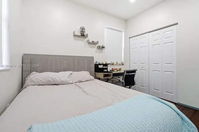 a bedroom with a bed and a closet