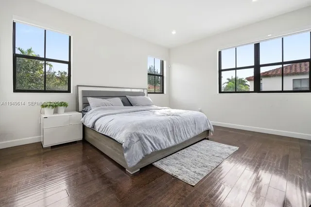 a bedroom with a bed table and window
