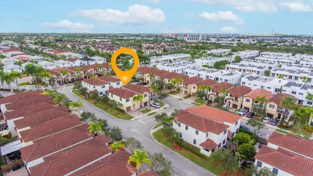 an aerial view of residential houses with outdoor space and swimming pool