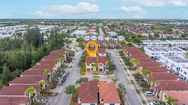 an aerial view of residential houses with outdoor space and river