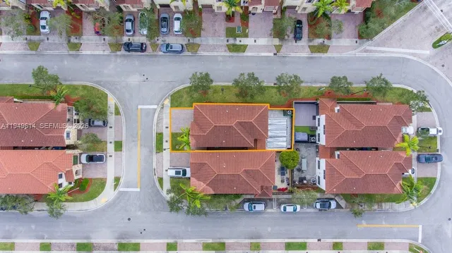 an aerial view of a house with a yard and a garden