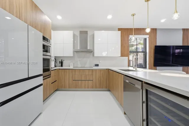 a kitchen with stainless steel appliances kitchen island granite countertop a sink a stove and cabinets