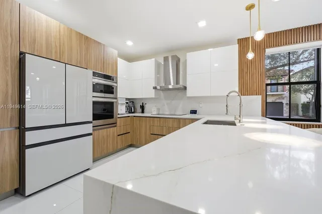 a kitchen with stainless steel appliances sink refrigerator and microwave