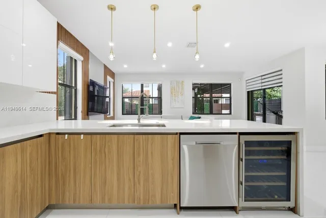 a large kitchen with granite countertop a stove and a sink