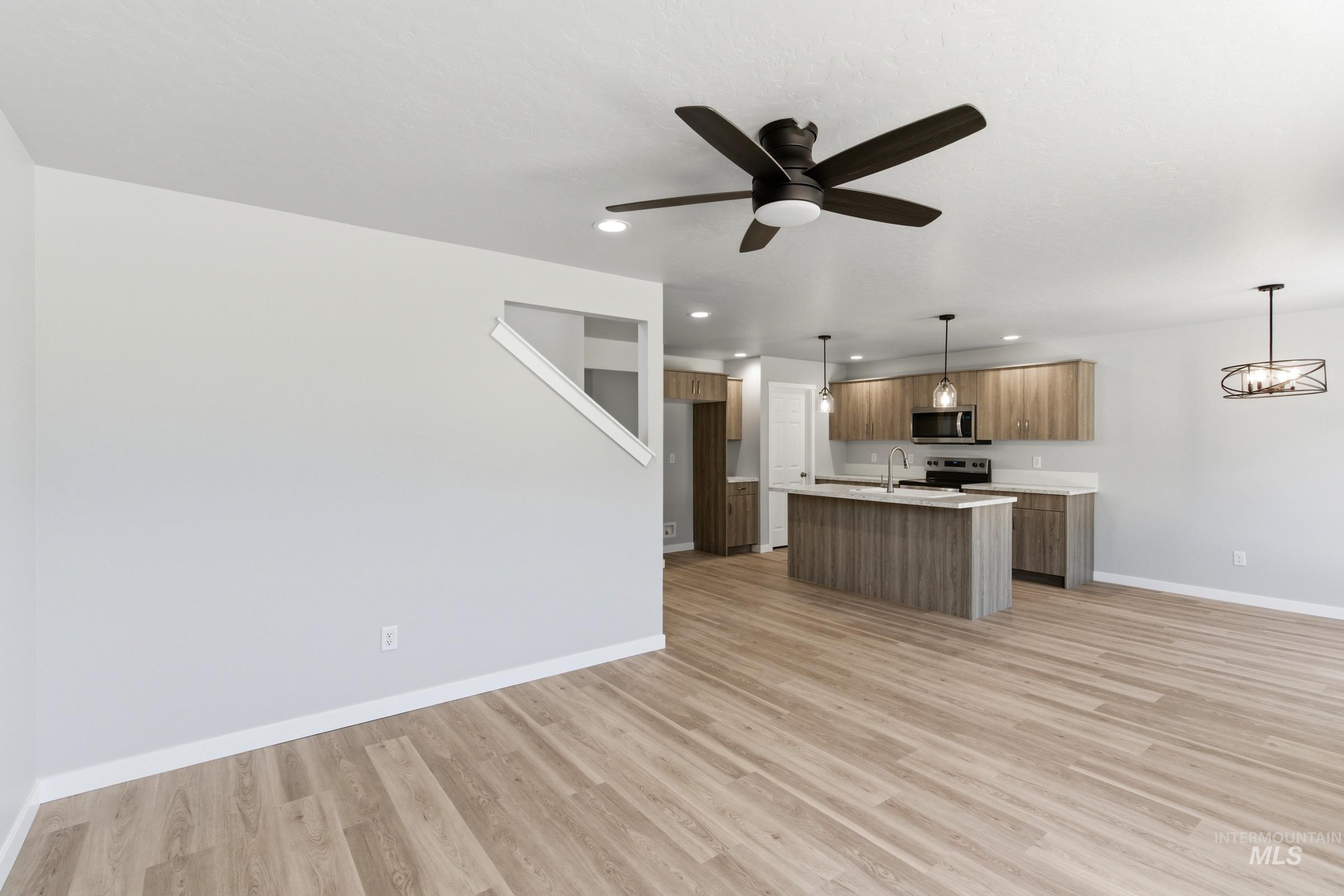2374 West Fallon Loop Nampa, ID 83651 - Photo 10 of 24 Open-concept living space with wood-finish flooring extending into the kitchen