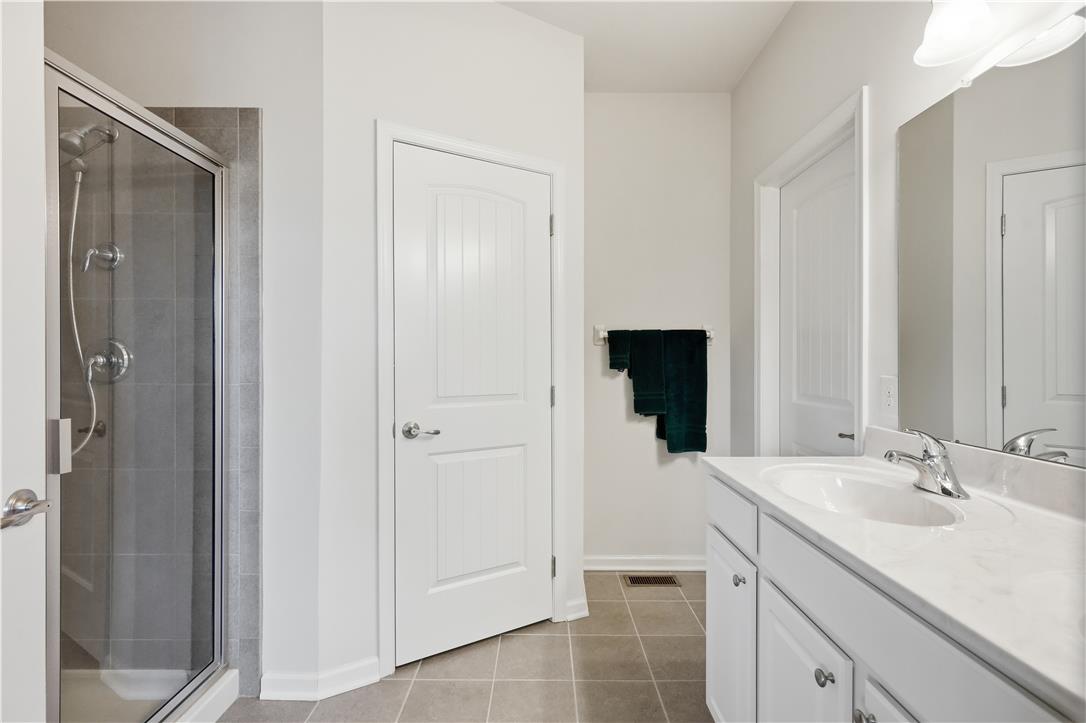 4120 Eveningstar Road Emmaus, PA 18049 - Photo 41 of 62 A sleek, contemporary shower enclosure and vanity with ample counter space define this pristine bathroom.