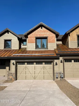 a view of house with backyard space and a car parked
