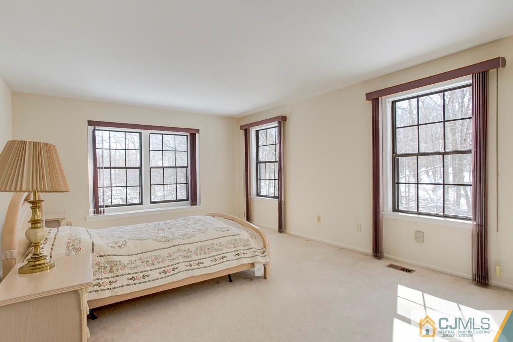4401 Stonehedge Road, Unit 44 Edison, NJ 08820 - Photo 11 of 24 a bedroom with a bed next to a window