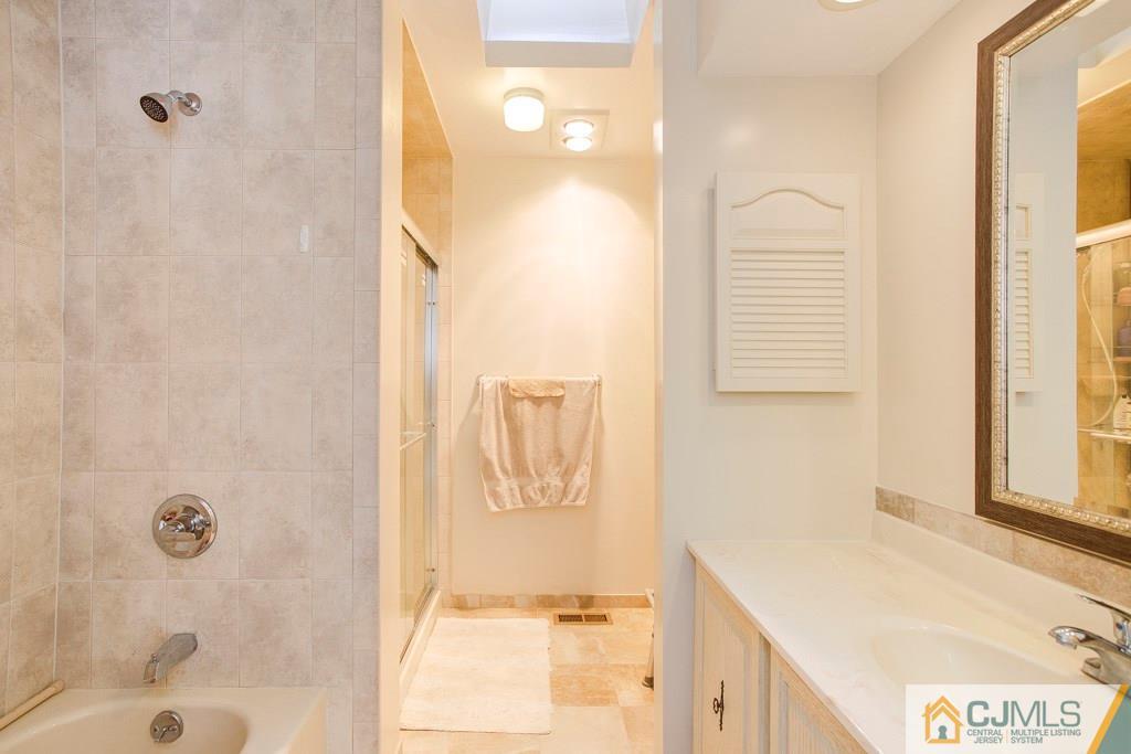 4401 Stonehedge Road, Unit 44 Edison, NJ 08820 - Photo 12 of 24 a bathroom with a shower