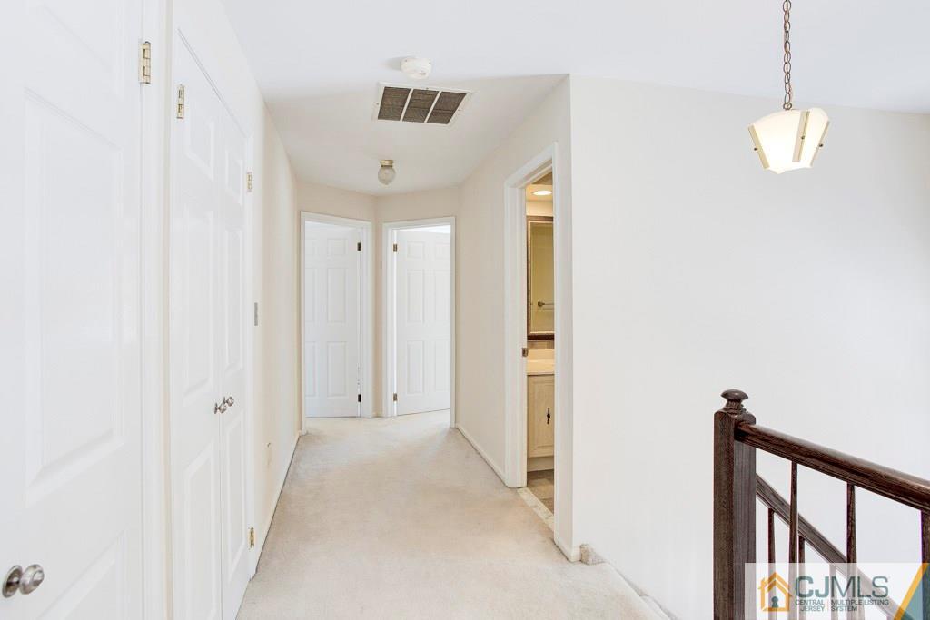 4401 Stonehedge Road, Unit 44 Edison, NJ 08820 - Photo 14 of 24 a view of a hallway with wooden floor