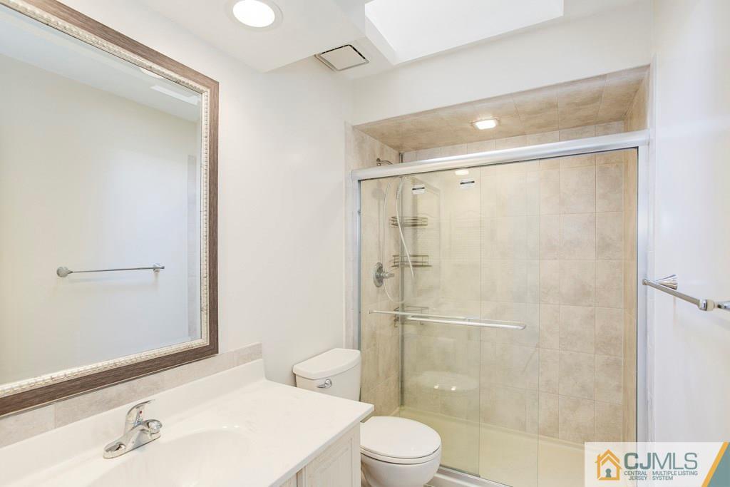 4401 Stonehedge Road, Unit 44 Edison, NJ 08820 - Photo 17 of 24 a bathroom with a shower and a toilet sink