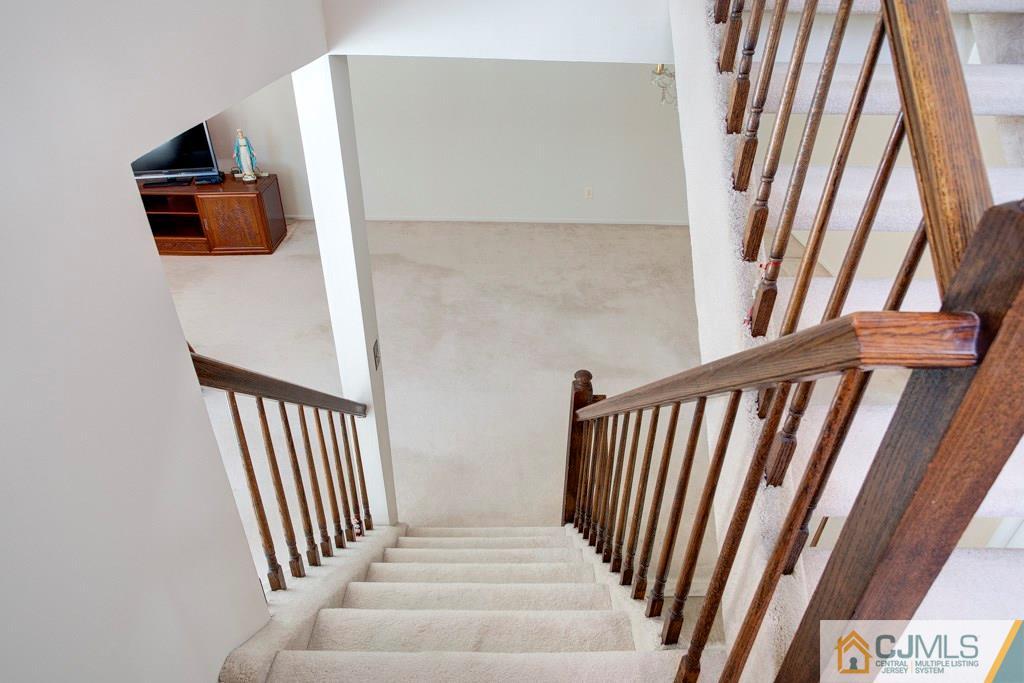 4401 Stonehedge Road, Unit 44 Edison, NJ 08820 - Photo 18 of 24 a view of staircase with white walls and a window