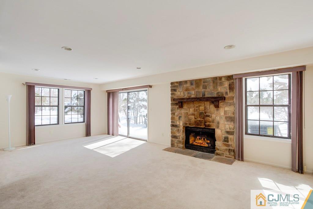4401 Stonehedge Road, Unit 44 Edison, NJ 08820 - Photo 19 of 24 a view of an empty room with a fireplace and a window