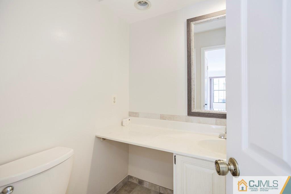 4401 Stonehedge Road, Unit 44 Edison, NJ 08820 - Photo 21 of 24 a bathroom with a sink a toilet and vanity