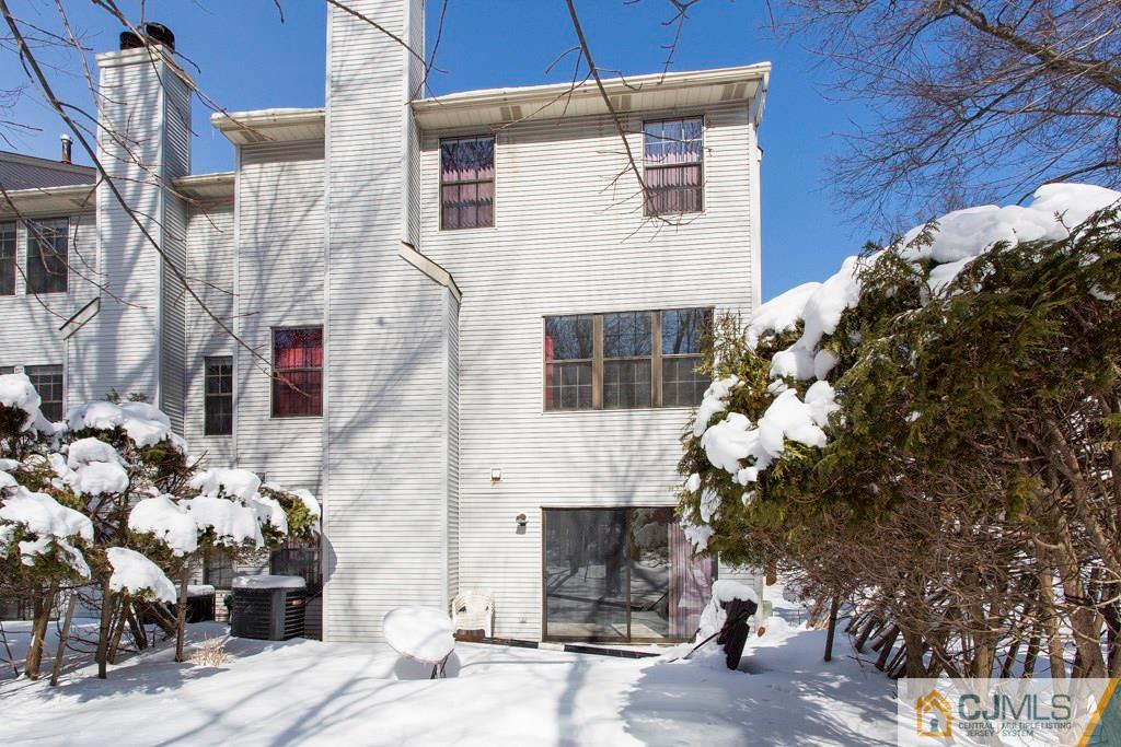 4401 Stonehedge Road, Unit 44 Edison, NJ 08820 - Photo 22 of 24 a front view of a house with a tree
