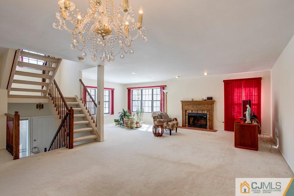 4401 Stonehedge Road, Unit 44 Edison, NJ 08820 - Photo 4 of 24 a view of a livingroom with fireplace and furniture
