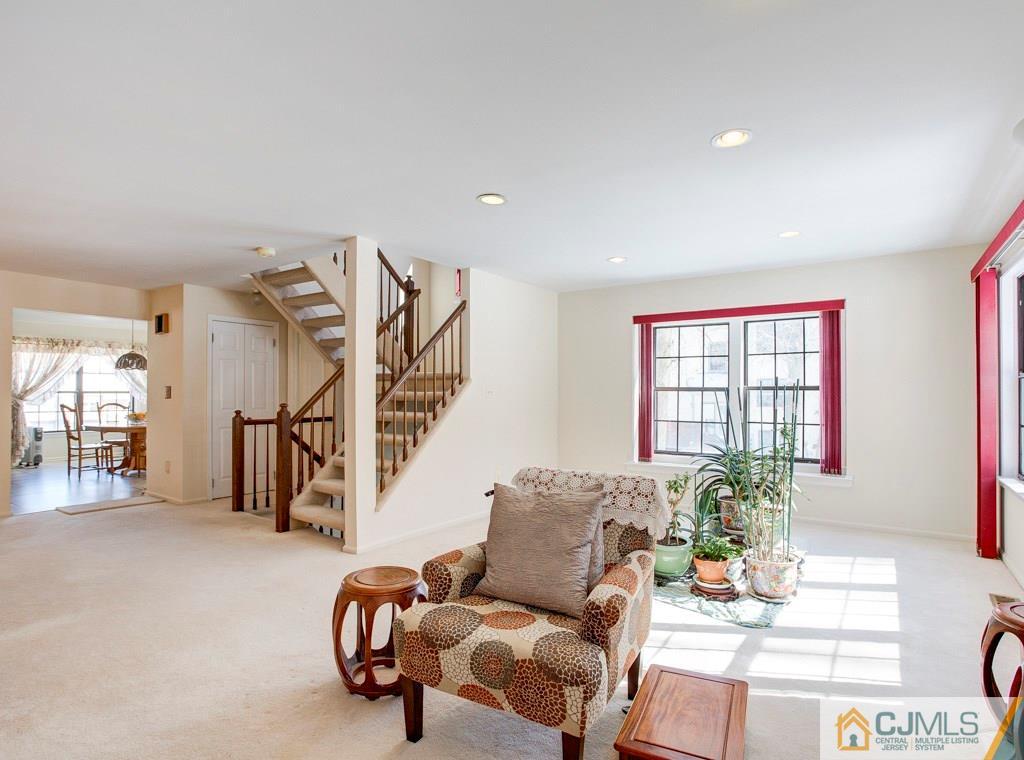 4401 Stonehedge Road, Unit 44 Edison, NJ 08820 - Photo 5 of 24 a living room with furniture and stairs