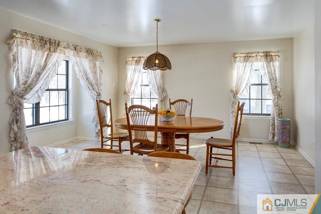 4401 Stonehedge Road, Unit 44 Edison, NJ 08820 - Photo 7 of 24 a view of a dining room with furniture and window