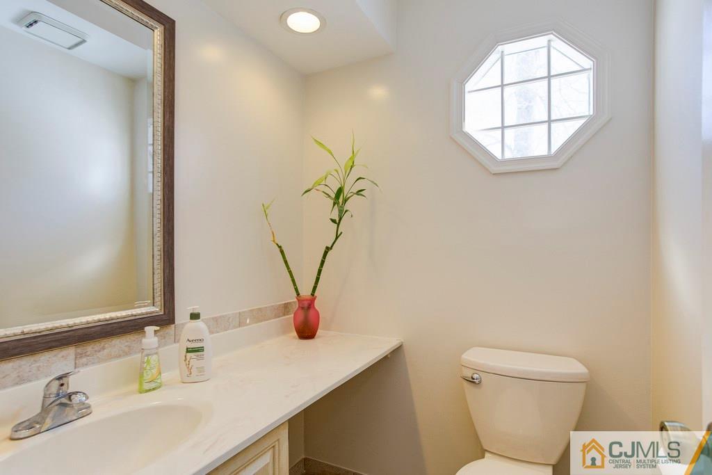 4401 Stonehedge Road, Unit 44 Edison, NJ 08820 - Photo 9 of 24 a bathroom with a toilet sink and mirror