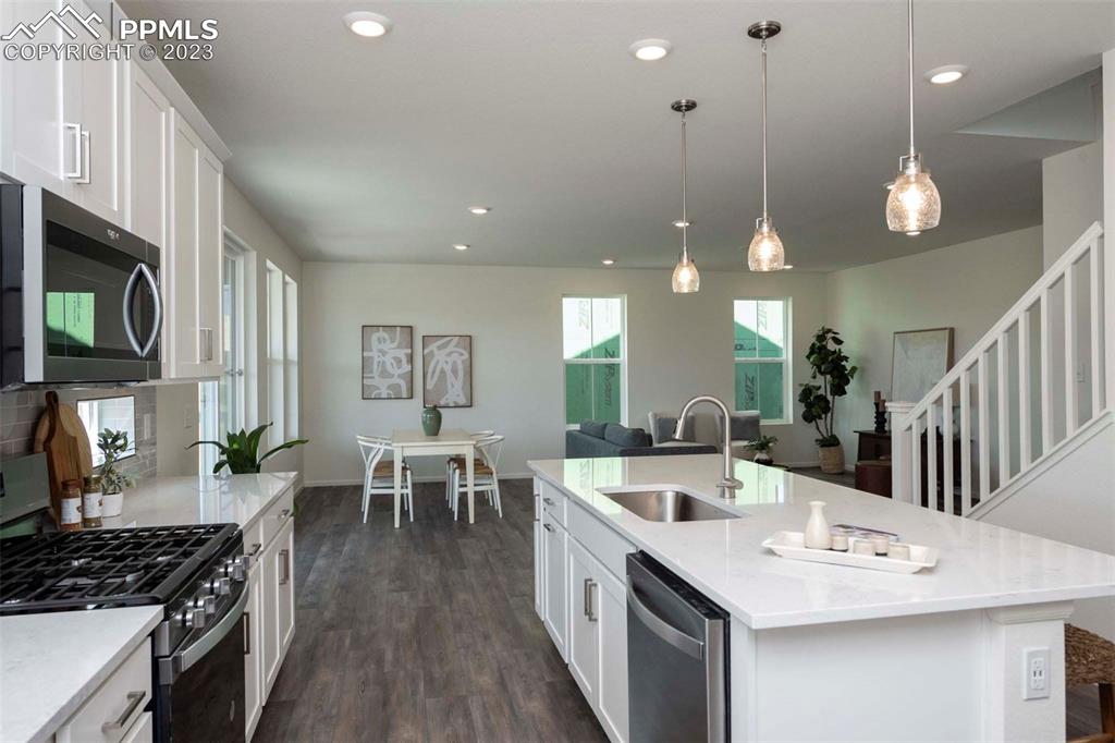 2050 Peachleaf Loop Castle Rock, CO 80108 - Photo 12 of 25 a large kitchen with a table and chairs