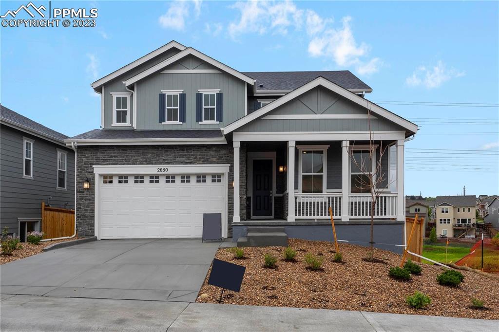 2050 Peachleaf Loop Castle Rock, CO 80108 - Photo 2 of 25 a front view of a house with a yard and garage