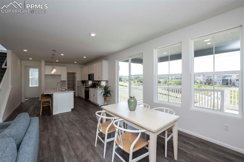 2050 Peachleaf Loop Castle Rock, CO 80108 - Photo 9 of 25 a view of a dining room with furniture window and wooden floor