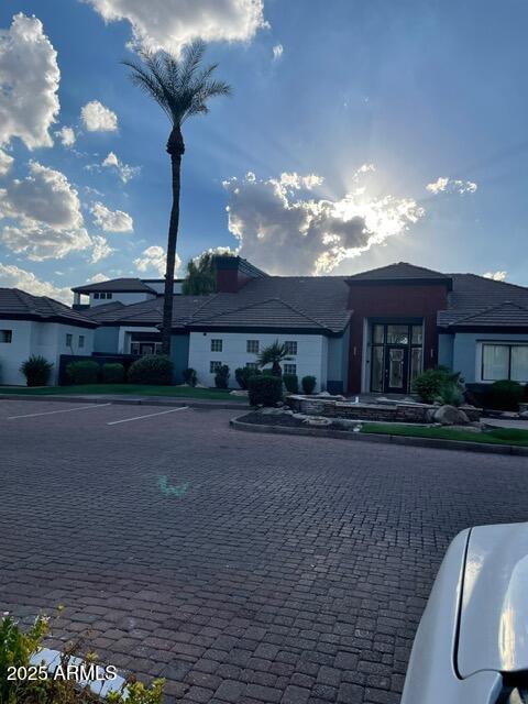a front view of a house with yard and parking