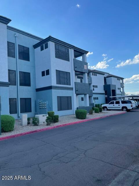 3848 North 3rd Avenue, Unit 1033 Phoenix, AZ 85013 - Photo 2 of 24 a front view of a building with cars parked
