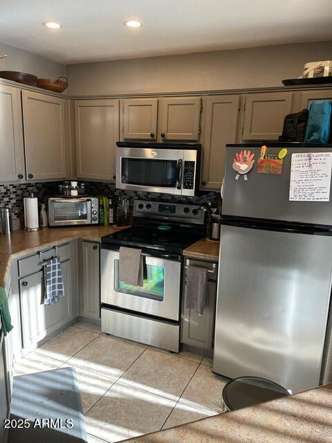 3848 North 3rd Avenue, Unit 1033 Phoenix, AZ 85013 - Photo 10 of 24 a kitchen with stainless steel appliances kitchen island granite countertop a stove a sink and a microwave