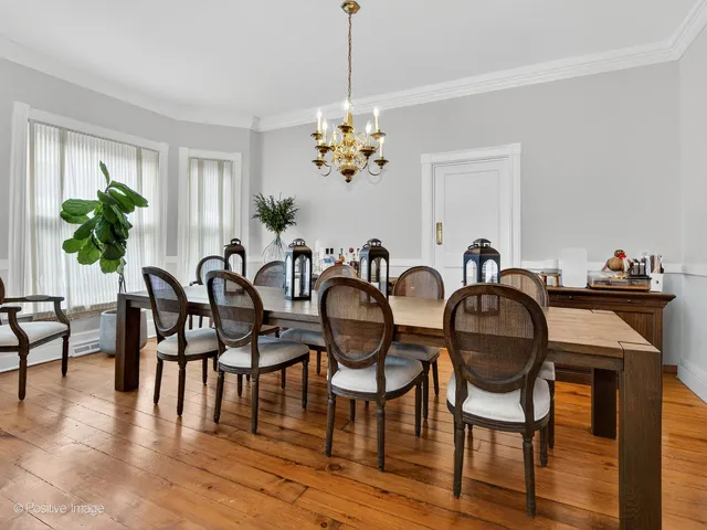 a view of a dining room with furniture wooden floor and chandelier