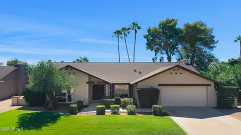 a front view of house with yard and outdoor seating