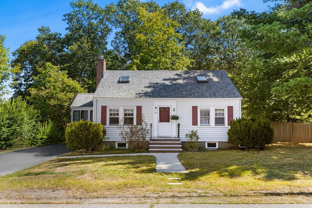 a front view of house with yard and trees