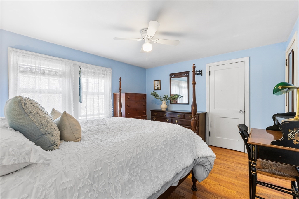 40 Bonad Road Stoneham, MA 02180 - Photo 17 of 38 a bedroom with a large bed and a chandelier