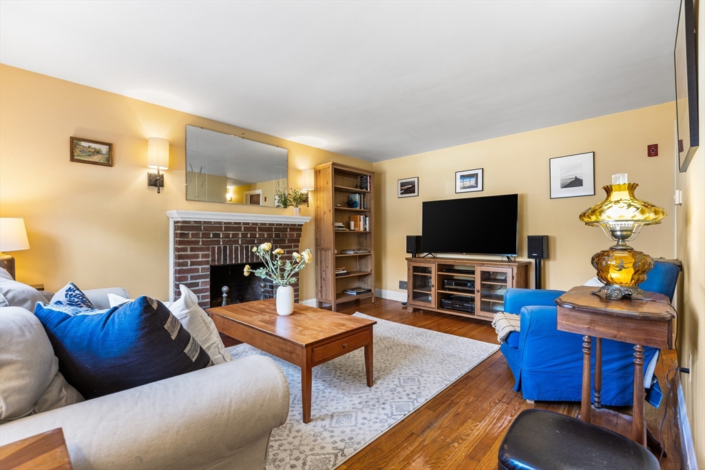 40 Bonad Road Stoneham, MA 02180 - Photo 2 of 38 a living room with furniture a flat screen tv and a fireplace