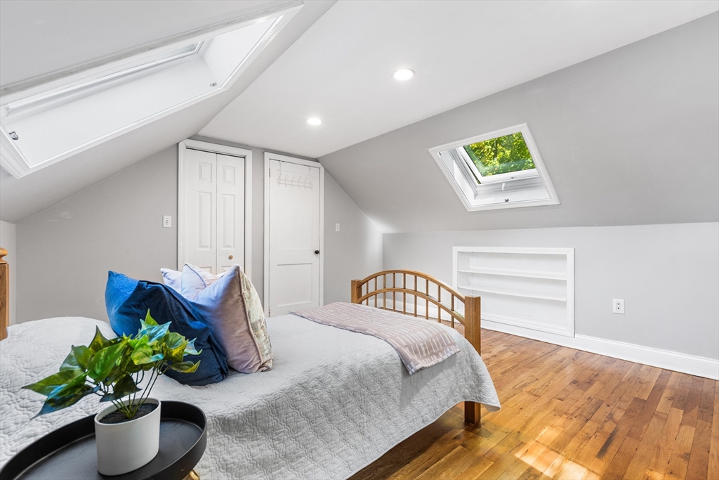 40 Bonad Road Stoneham, MA 02180 - Photo 22 of 38 a bedroom with a bed and a potted plant