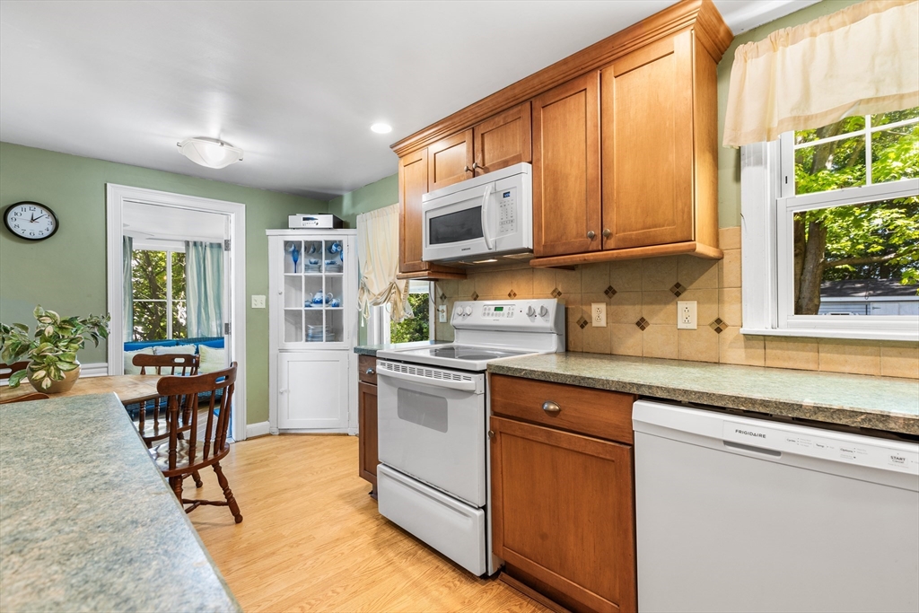 40 Bonad Road Stoneham, MA 02180 - Photo 6 of 38 a kitchen with stainless steel appliances granite countertop a stove a sink and a microwave