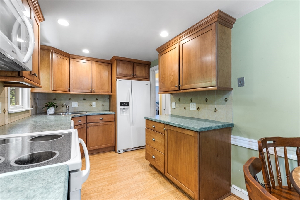 40 Bonad Road Stoneham, MA 02180 - Photo 10 of 38 a kitchen with granite countertop a sink stove and cabinets