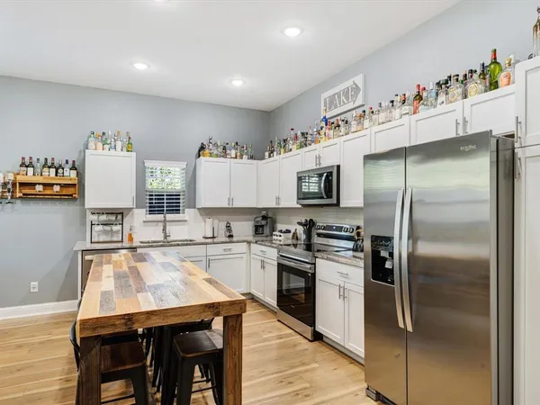 a bedroom with a large bed and a chandelier