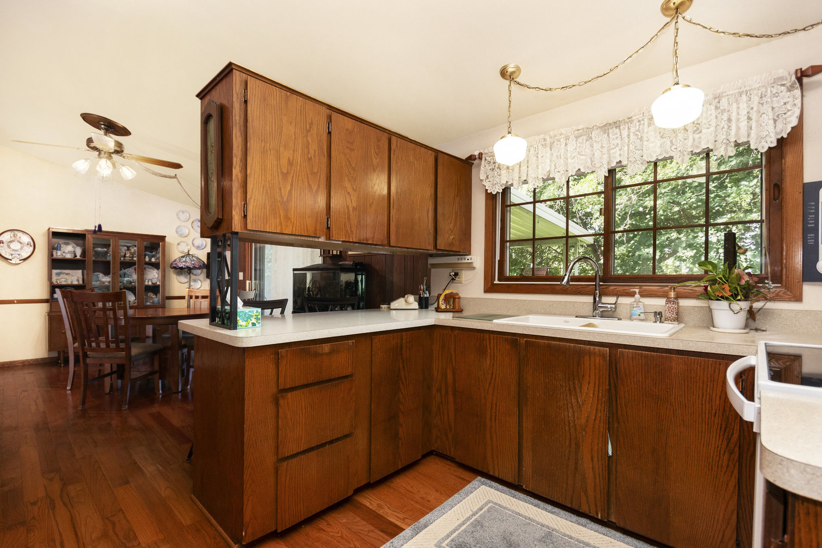 2S810 Bliss Road Batavia, IL 60510 - Photo 17 of 28 a kitchen with a sink and wooden cabinets