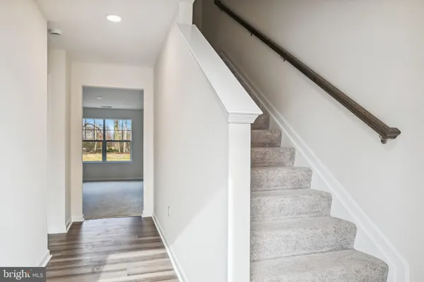 a view of staircase with white walls and windows