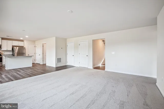 a view of a kitchen with a sink and a refrigerator