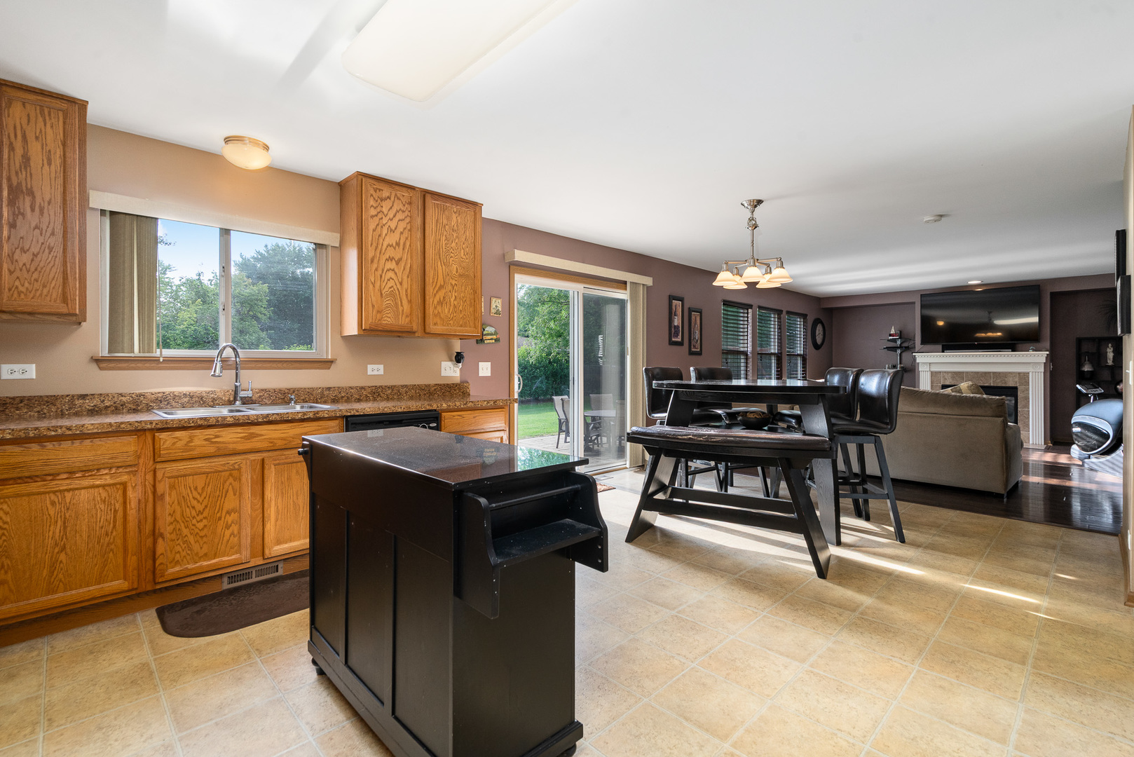 16320 Spring Creek Lane Plainfield, IL 60586 - Photo 11 of 40 a kitchen with kitchen island granite countertop a sink counter and chairs
