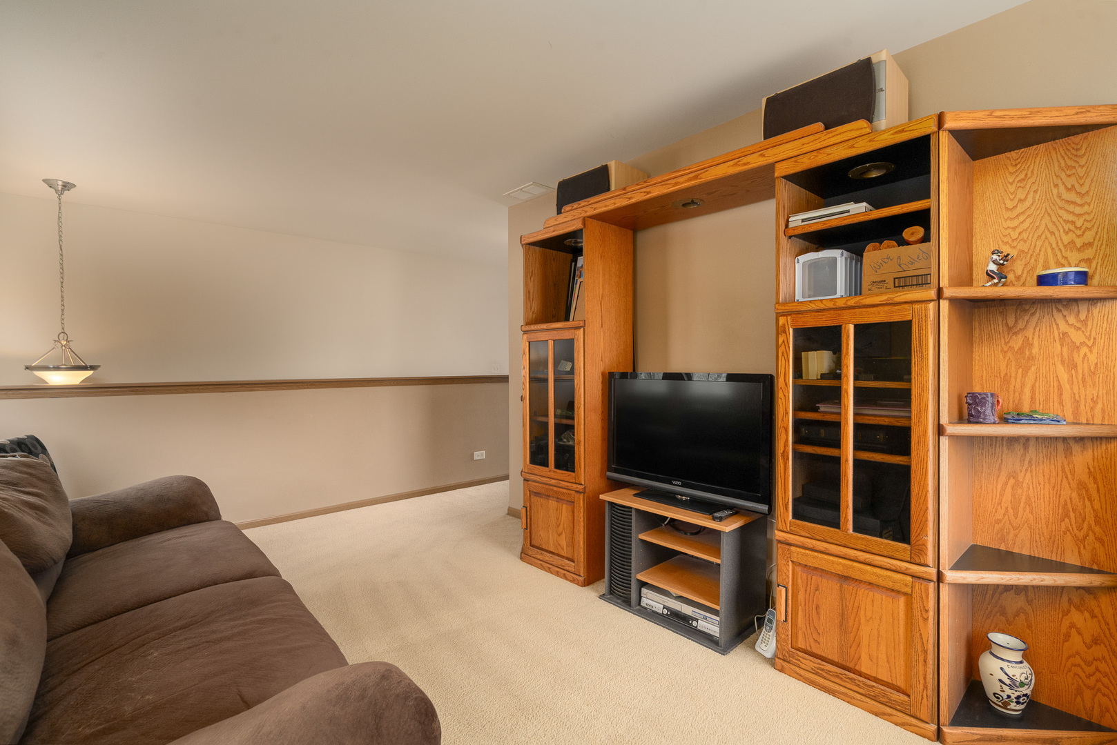 16320 Spring Creek Lane Plainfield, IL 60586 - Photo 15 of 40 a living room with a flat screen tv and painted walls