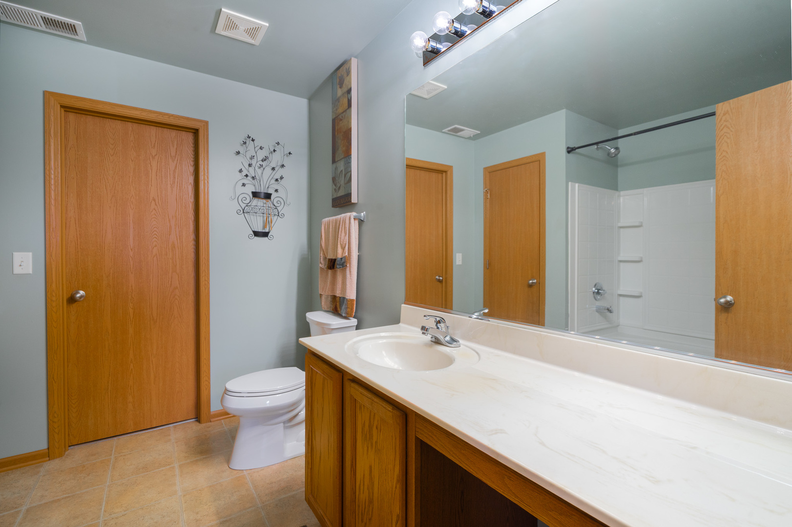16320 Spring Creek Lane Plainfield, IL 60586 - Photo 18 of 40 a bathroom with a double vanity sink toilet and shower