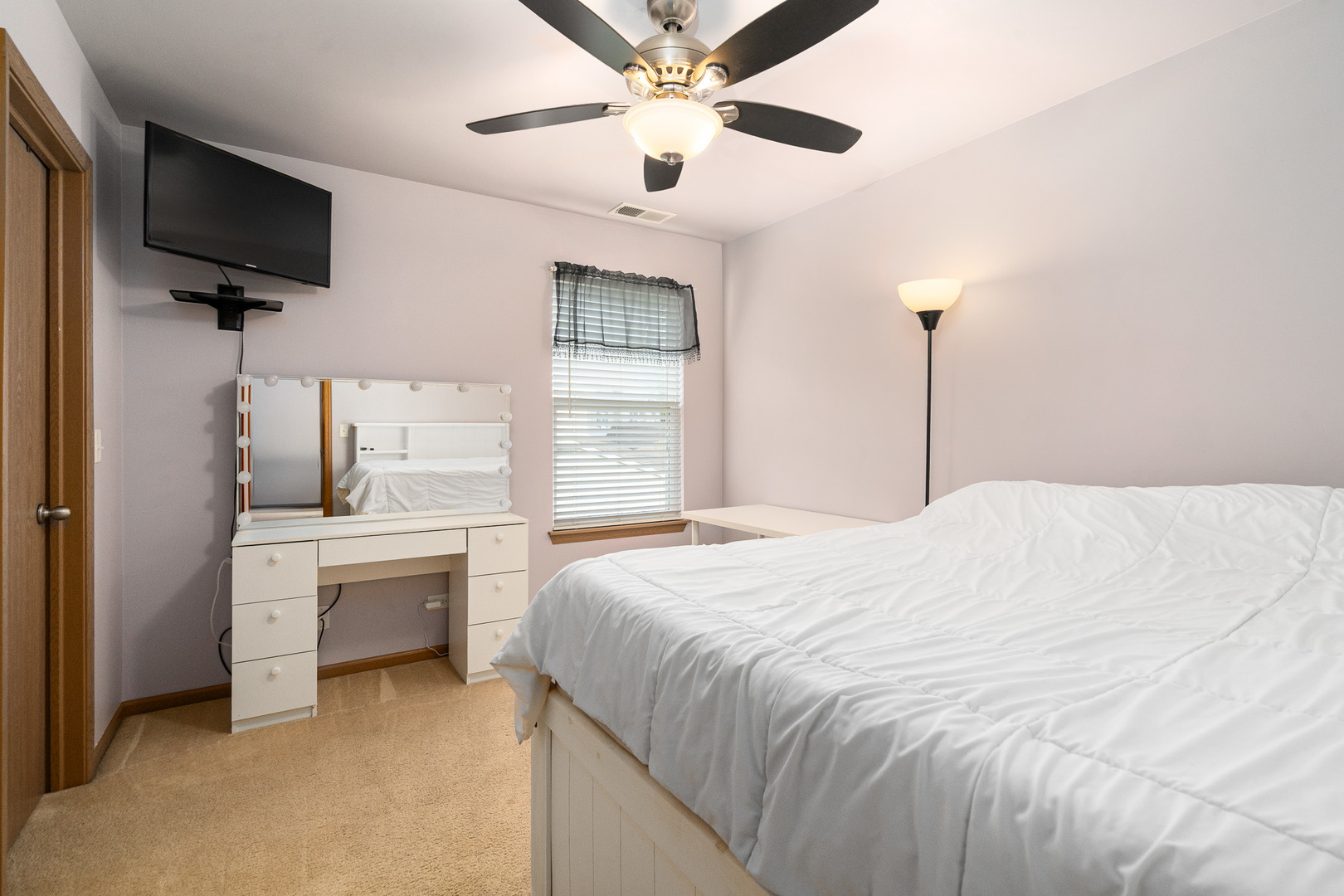 16320 Spring Creek Lane Plainfield, IL 60586 - Photo 22 of 40 a bedroom with a bed and a flat screen tv
