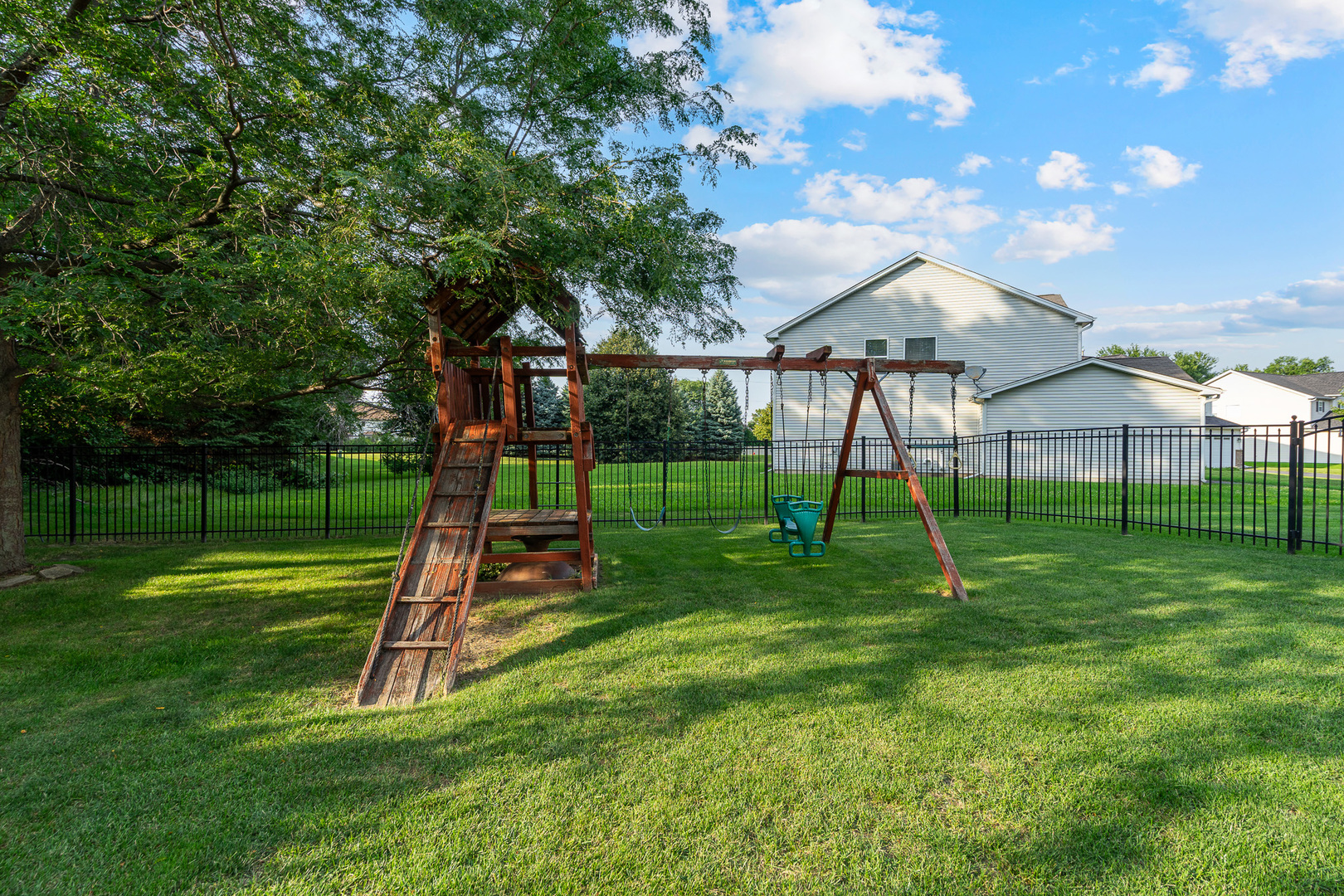 16320 Spring Creek Lane Plainfield, IL 60586 - Photo 30 of 40 a view of a backyard with a slide