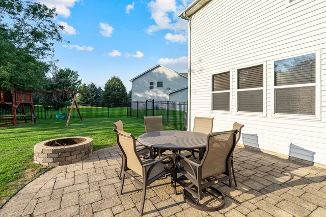 a view of a house with backyard sitting area and garden