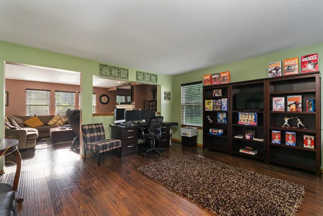 a living room with furniture and wooden floor