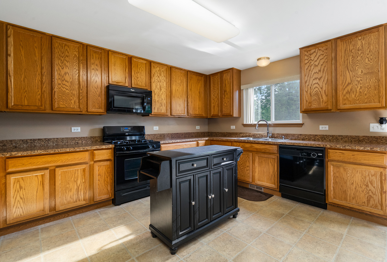 16320 Spring Creek Lane Plainfield, IL 60586 - Photo 8 of 40 a kitchen with stainless steel appliances granite countertop wooden cabinets a stove top oven a sink and dishwasher